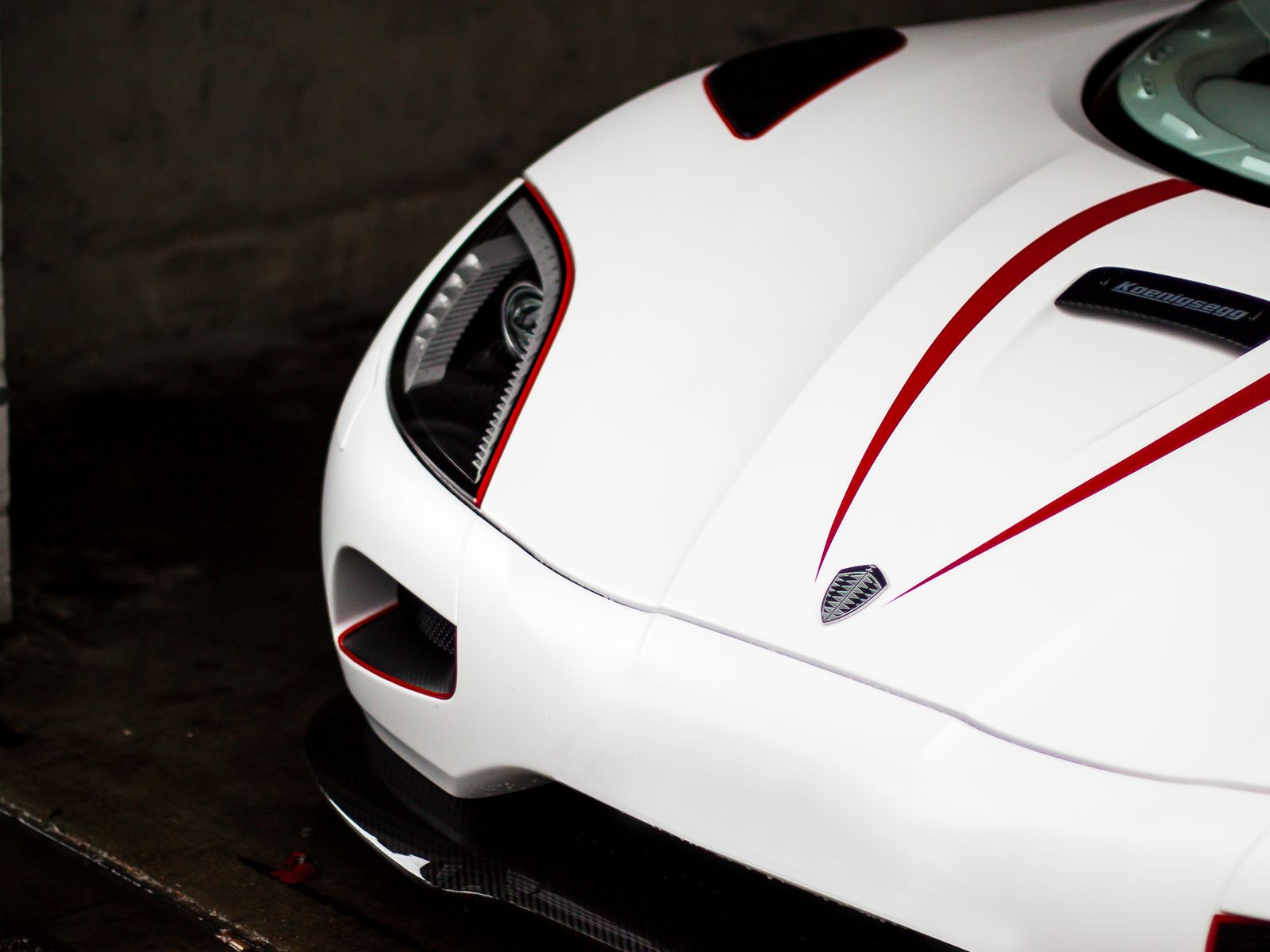 The carbon front splitter and bonnet vents of a white supercar