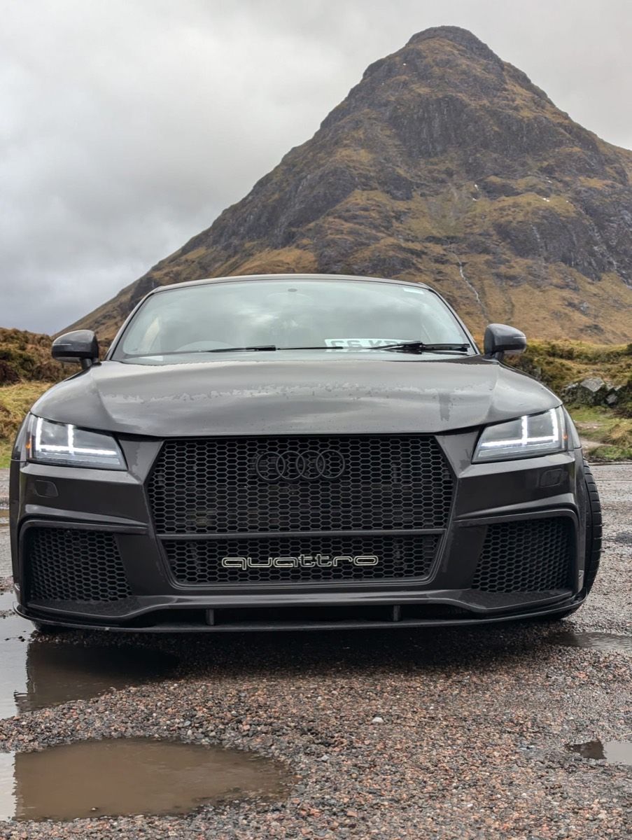A grey Audi TT RS parked beneath Buachaille Etive Mor in Glencoe