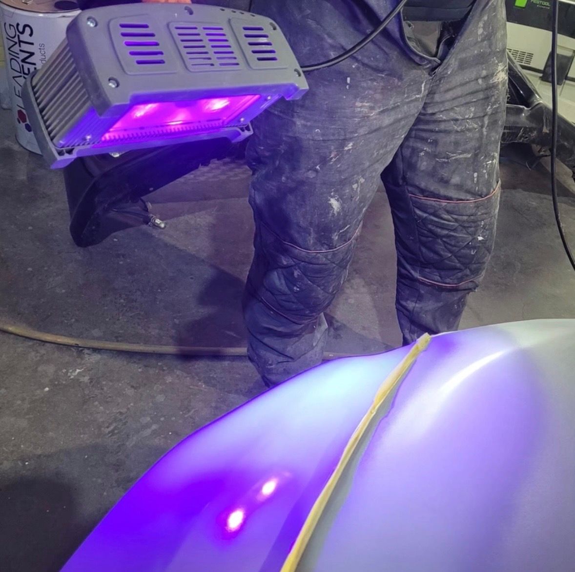A UV lamp curing a filled panel repair